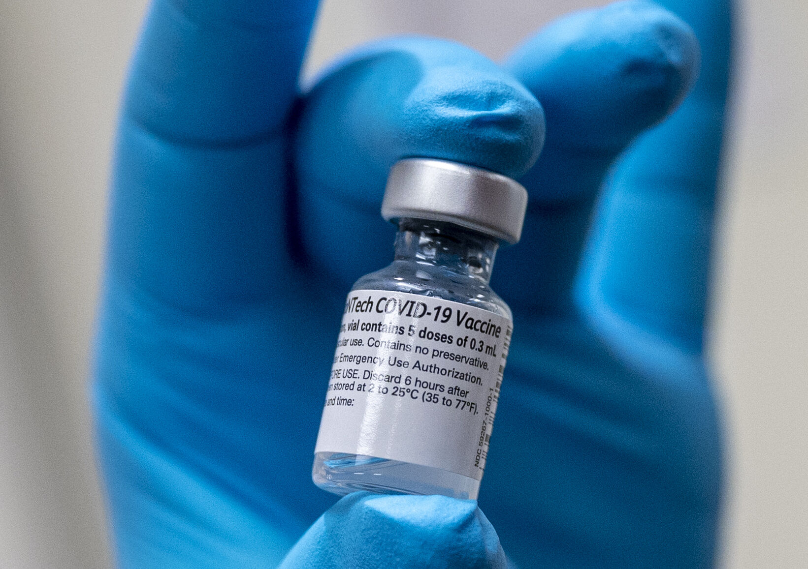 Army Spc. Angel Laureano holds a vial of the COVID-19 vaccine, Walter Reed National Military Medical Center, Bethesda, Md., Dec. 14, 2020. (DoD photo by Lisa Ferdinando)